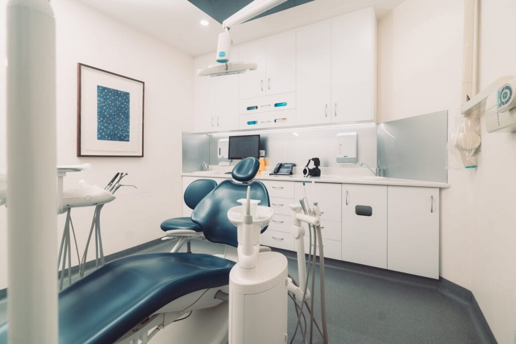 The Dentist Surrey Hills is equipped with a comfortable blue chair and state-of-the-art dental equipment.